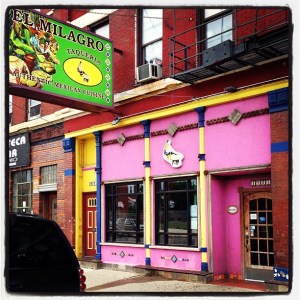 I know it blends in with the other buildings, but it's the bright pink building in the center of the picture...